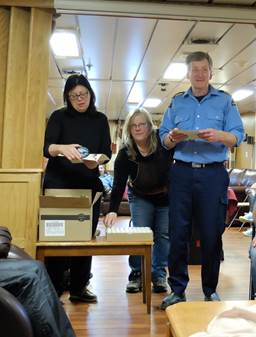 Mary-Lynn, Jane and Captain Potts handing out the end-of-trip goodies: certificate, badge and water sample
