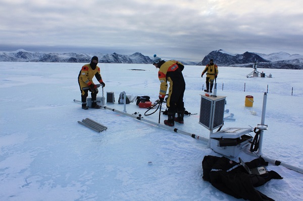 Setting up a stationary ice penetrating radar system to monitor an ice island’s thickness change. Photo credit: Graham Clark. 