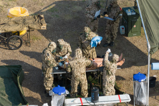 Des soldats en tenue de protection exécutent des manoeuvres sur un mannequin d’entraînement