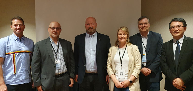 Photo de groupe avec Ralph Eldridge, Dr Randy Billard, Dr Paul Brett, Kelley Santos, Steve Kavanagh et Dr Wei Qiu (de gauche à droite). Ils sont tous debout, souriant et portant des tenues professionnelles.
